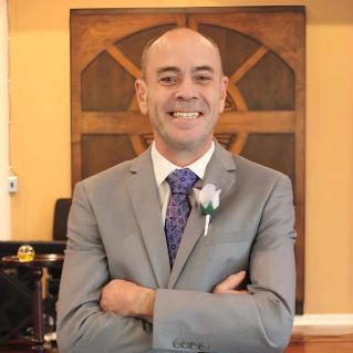 Close-up portrait of an African American priest in a church setting, highlighting faith and spirituality.